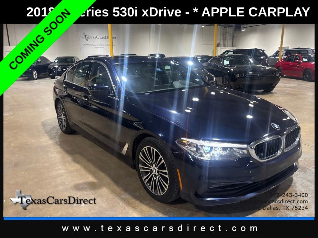 Blue BMW before enhancement under distracting indoor lights